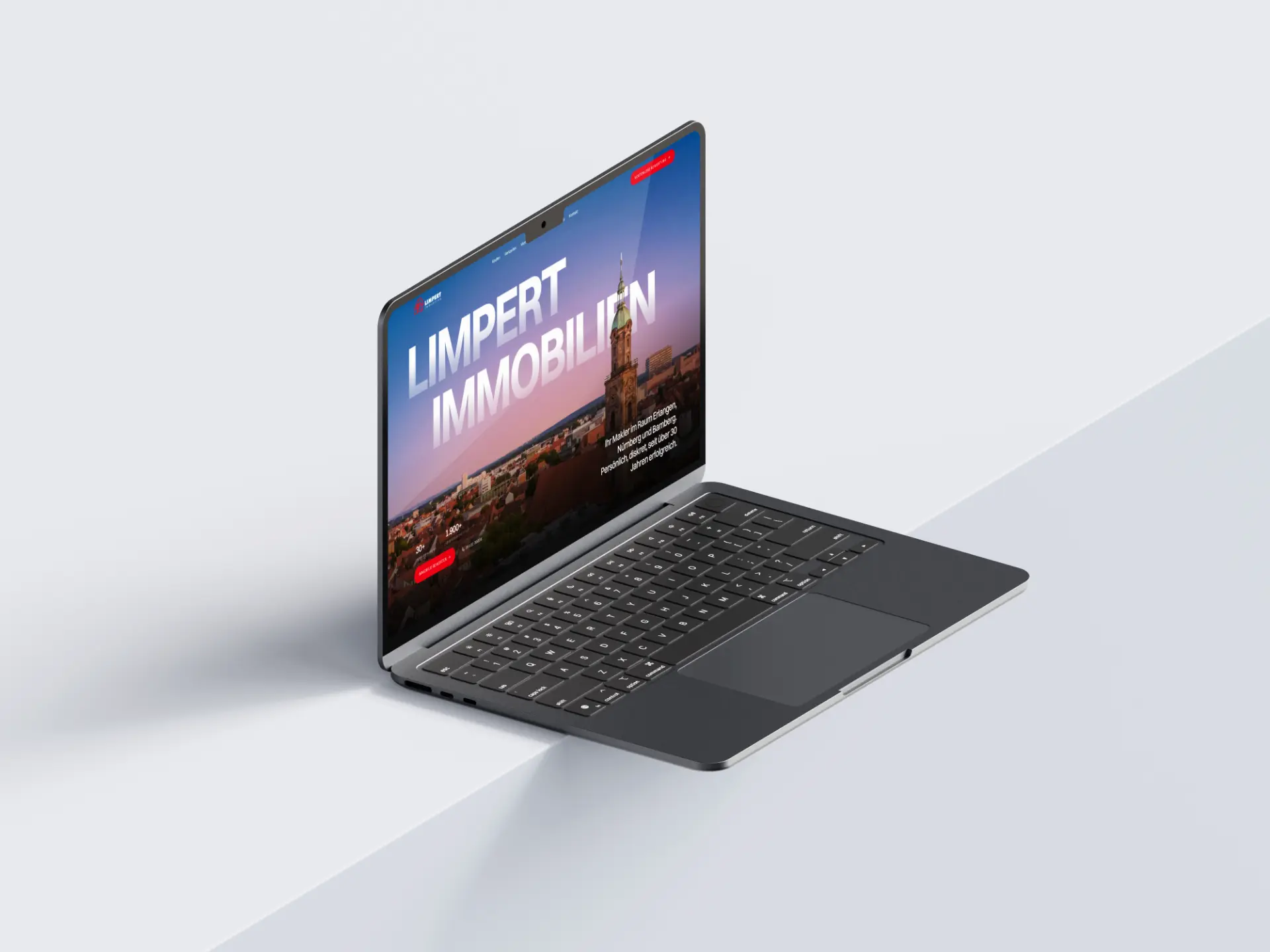 Startseite von Limpert Immobilien mit Stadtansicht auf einem Laptop